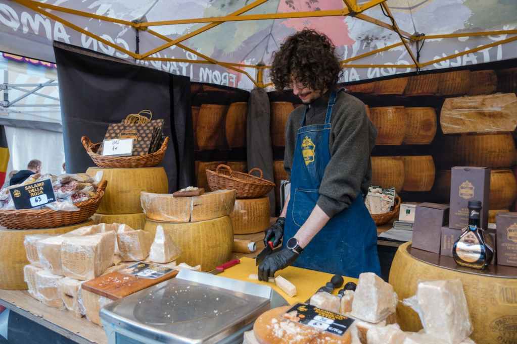 un giovane venditore di formaggio in un banco